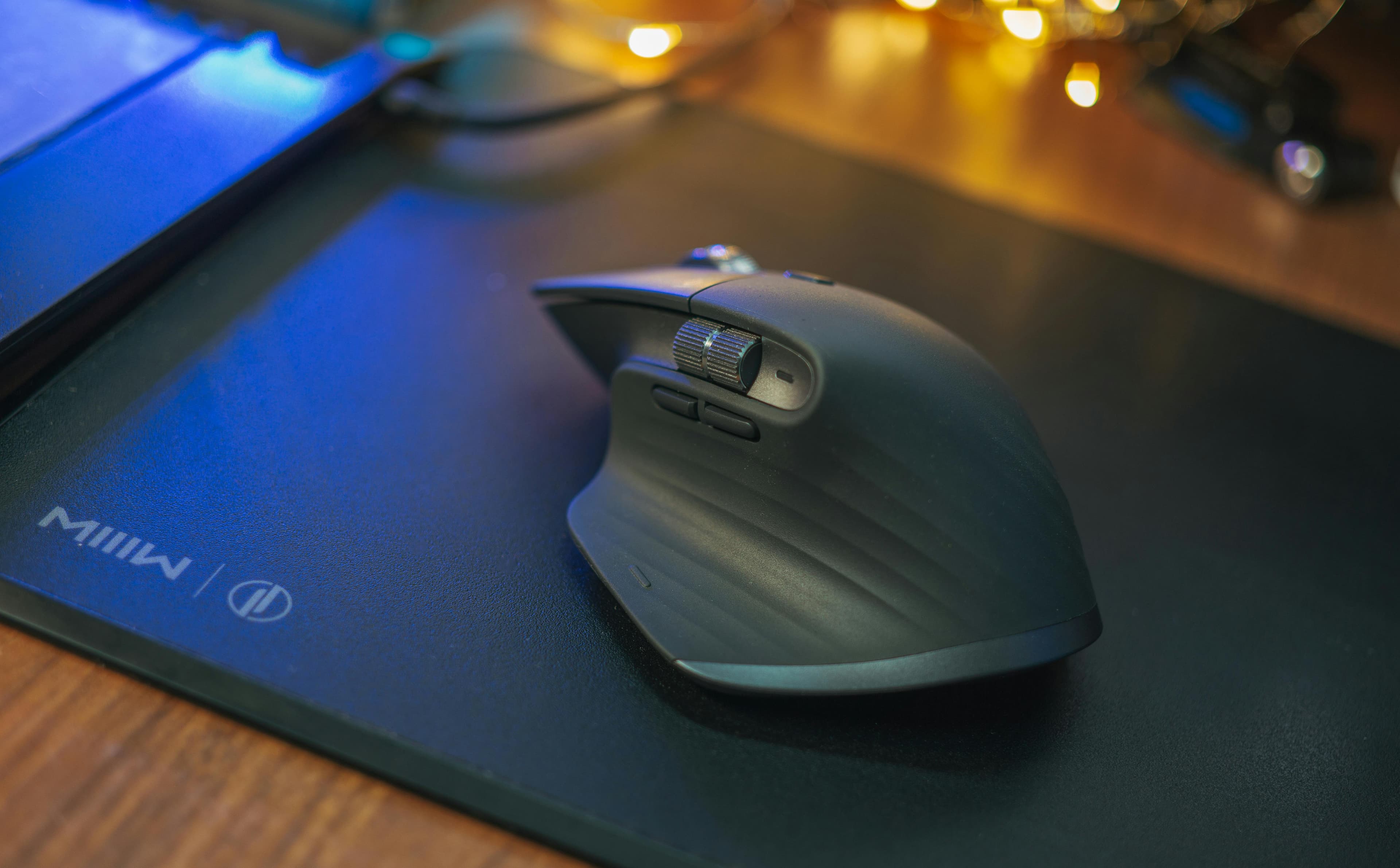 Ambient desk scene with a premium mousepad surface.